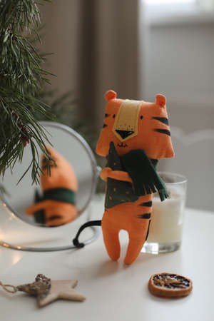 cute soft toy tiger with decorations on a cozy Christmas or New Year background. symbol of 2022, oriental calendar conceptの写真素材