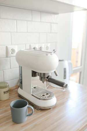white stylish coffee machine in cozy kitchen interior