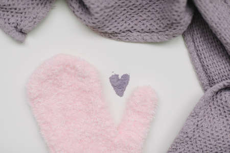 Minimal flat lay composition of massage mitten washcloth and a heart made of violet powder on a...