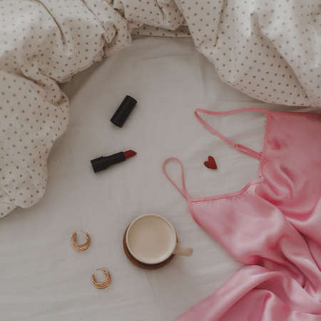 Beautiful feminine flatlay frame arrangement with lingerie, coffee cup, jewerly and other accessories top viewの写真素材