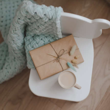 Composition with a gift, book, cup of coffee and plaid top viewの写真素材