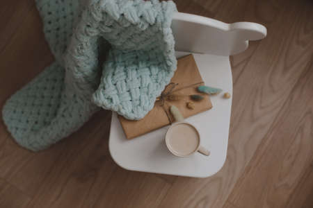 Composition with a gift, book, cup of coffee and plaid top viewの写真素材