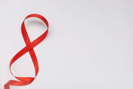 Eight made of red ribbon. 8 March greeting card template. International Womens day background, banner, poster or brochureの写真素材
