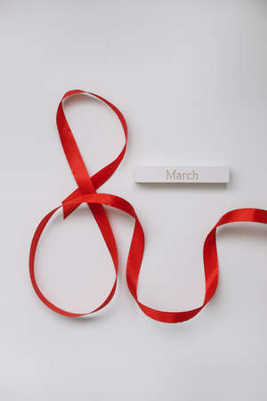 Eight made of red ribbon. 8 March greeting card template. International Womens day background, banner, poster or brochureの写真素材