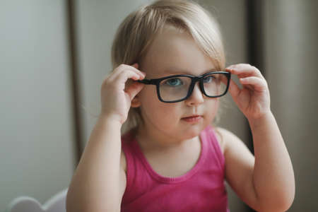 portrait of a little funny girl in eyeglassesの写真素材