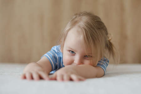 Portrait of child indoors. Happy funny toddler girl at home.の写真素材