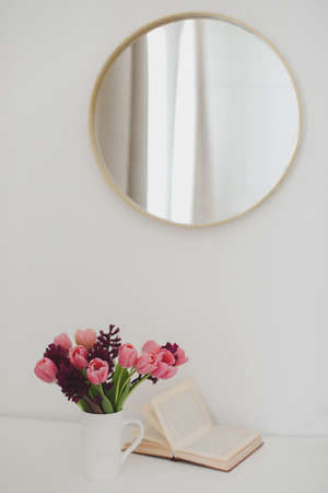 cozy spring home decor with a pink tulip bouquet in daylight. Spring stll life, birthday, Easter concept.の写真素材