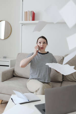 Creative photo of a busy business woman working with documents at workplace in a modern office. office manager or freelancer in a stylish room.の写真素材