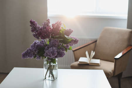 Home interior decor, bouquet of lilacs in a vase on table.の写真素材
