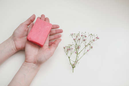 Natural handmade soap bar and flowers, spa organic soap, sustainable lifestyle.