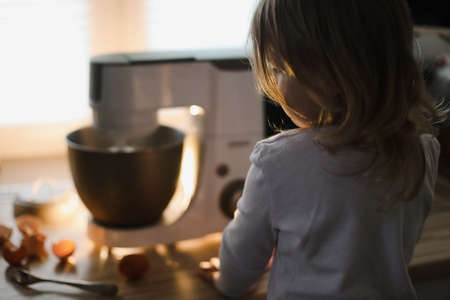 child baking pie in a cozy kitchen at homeの写真素材