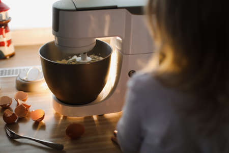 child baking pie in a cozy kitchen at home
