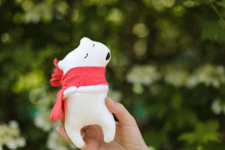 Eco-friendly cute handmade toy bear on grass at sunny summer dayの写真素材