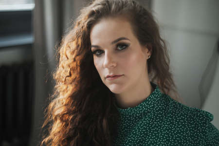Portrait of a beautiful sensual young woman with curly hair.