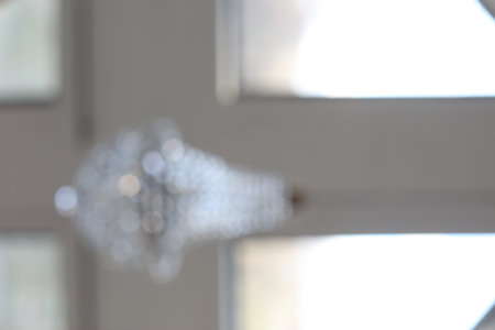 defocused abstract background of beautiful vintage crystal chandelier in light a roomの写真素材