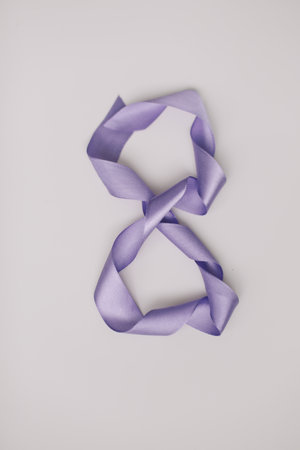 Eight made of purple ribbon. 8 March greeting card template. International Womens day background,...