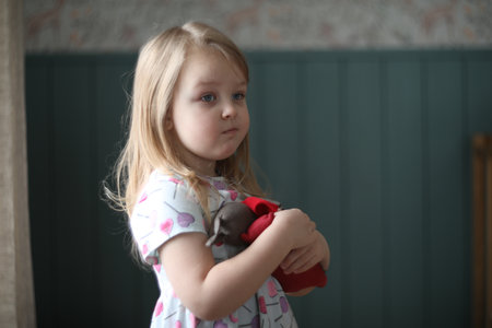 Portrait of a lovely little girl at home. Attractive lovely sweet curious cheerful smart toddler...