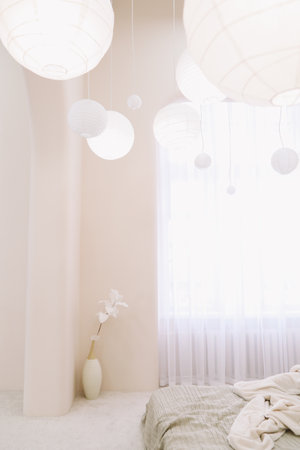 Stylish and cozy interior of the bedroom. Vase with white flowers, home decorの写真素材