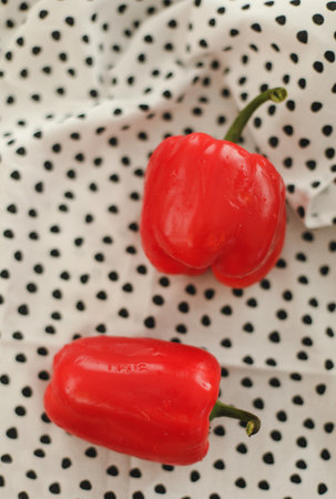 Colorful mini paprika on a bright dish towel. Red Colorful sweet peppers on a table. Top viewの写真素材