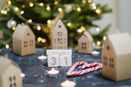 December 31 on white cubes calendar on a background with glowing garland. Christmas, winter, new year conceptの写真素材