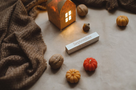 Autumn cozy home interior with a cup, candles, plaid. Hygge home decor. Halloween and Thanksgiving conceptの写真素材