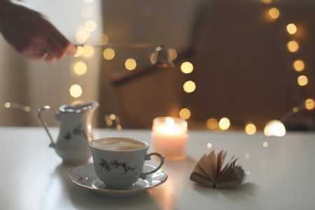 Autumn cozy home interior with a cup of coffee, candles. Hygge home decor. Halloween and Thanksgiving conceptの写真素材