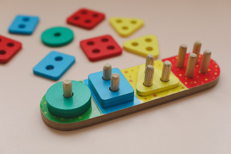 Sorter on neutral background. Multicolored logic sorter close up. Wooden educational logic toy for kids. Montessori games for early child developmentの写真素材
