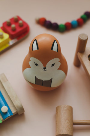 Wooden doll tumbler-toy. Eco-friendly colored wooden educational toys according to the Montessori method for preschool children. Childrens wooden toys for kids.の写真素材
