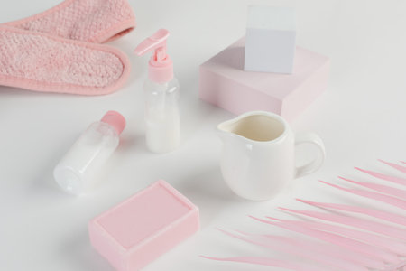 Skincare routine. Pink Women skincare products on white background. Soap, facial foam, cleansing, serum, cream lotion, toothbrush, lipstick. Beauty concept. Natural cosmetic pink flat lay top viewの写真素材