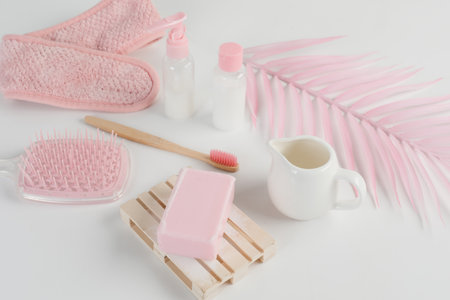 Skincare routine. Pink Women skincare products on white background. Soap, facial foam, cleansing, serum, cream lotion, toothbrush, lipstick. Beauty concept. Natural cosmetic pink flat lay top viewの写真素材