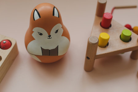 Wooden doll tumbler-toy. Eco-friendly colored wooden educational toys according to the Montessori method for preschool children. Childrens wooden toys for kids.の写真素材