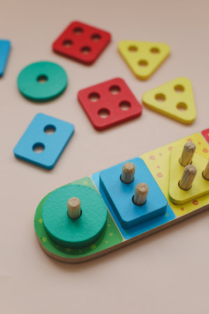 Sorter on neutral background. Multicolored logic sorter close up. Wooden educational logic toy for kids. Montessori games for early child developmentの写真素材