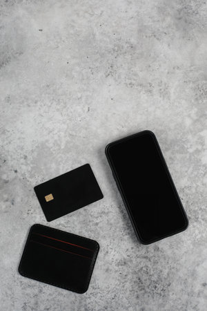 blank screen mobile phone and credit card isolated on gray background, Premium banking concept. Logo...