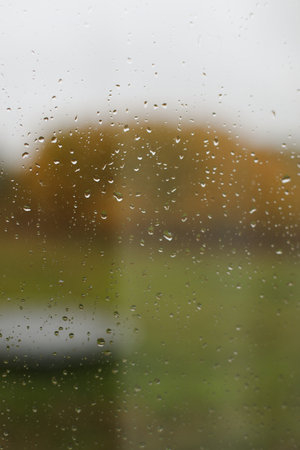Water drops on glass texture abstract autumn nature background,Selective focus. Natural pattern of...