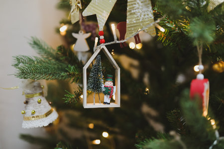 Christmas and New years eve Background. Close up of balls on christmas tree. Bokeh garlands in the background. New Year concept. Decorated Christmas tree on blurred, sparkling and fairy backgroundの写真素材