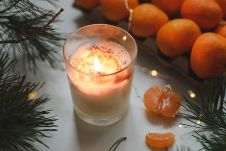 Candle, tangerines and pine. Christmas background with fir tree branches and tangerines merry christmas and happy new year. High quality photoの写真素材