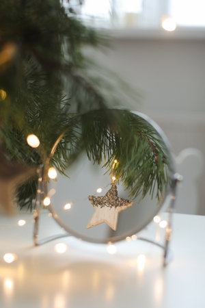 Christmas and New years eve Background. Close up of balls on christmas tree. Bokeh garlands in the background. New Year concept. Decorated Christmas tree on blurred, sparkling and fairy backgroundの写真素材