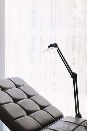 equipment in a modern cosmetology clinic. Lamp and comfortable Chair in a beauty salonの写真素材