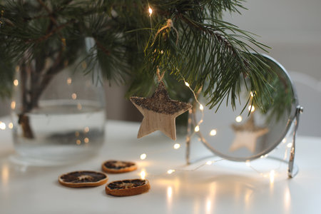 Christmas and New years eve Background. Holiday Template with Christmas toy on fir tree. Web banner with copy space for design. Close up of balls on christmas tree. Bokeh garlands in the backgroundの写真素材