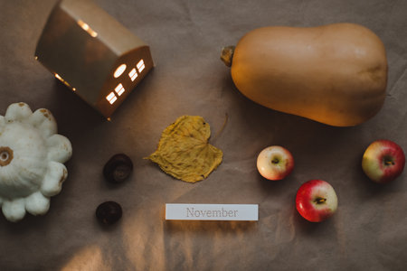 Hello autumn composition leaves, candles and pumpkin top view. Cozy home decor. Thanksgiving conceptの写真素材