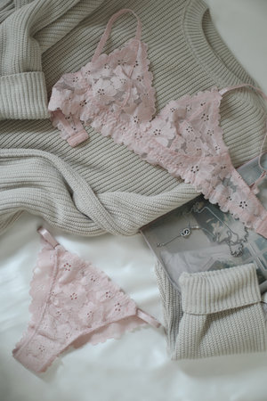 Womans silk lingerie on the white bed sheets. Valentines day concept. Lace female underwear. Beauty, fashion blogger concept. Female bra, panties.の写真素材