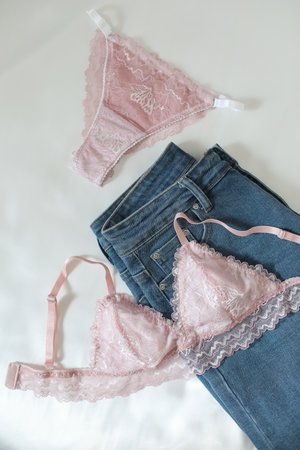 Womans silk lingerie on the white bed sheets. Valentines day concept. Lace female underwear. Beauty, fashion blogger concept. Female bra, panties.の写真素材