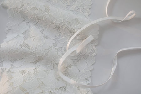 delicate silk lace, Beautiful guipure fabric, ribbon tapes on white background. lace fabric. soft,...