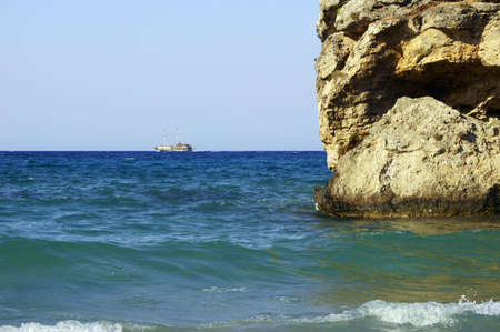 sailboat and rock on coast at Zakynthos island, Greeceの写真素材