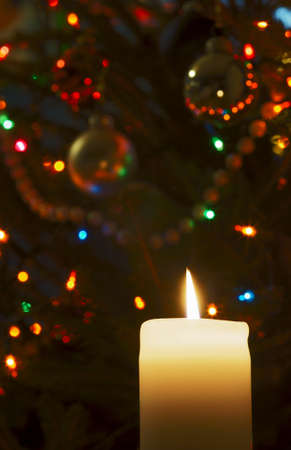 Flame of candle and Christmas tree ornamentsの写真素材