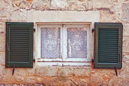 window with shutter and net curtain, Zakynthos island, Greeceの写真素材