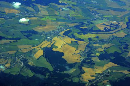 view from the plane of the forests, meadows and cultivated fields in Europe 