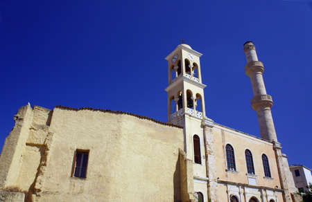 Orthodox church with a bell tower and minaret in the town of Chania, Creteの写真素材