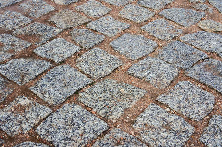 The road paved with granite cobblestones 
