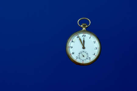 old pocket watch on a blue background